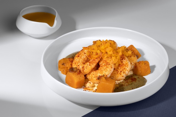 Chef Jérôme Banctel Signature dish for Business class from Paris in December 2024 and in March and May 2025. Crevettes sautées, sauce butternut relevée, risotto de fregola.